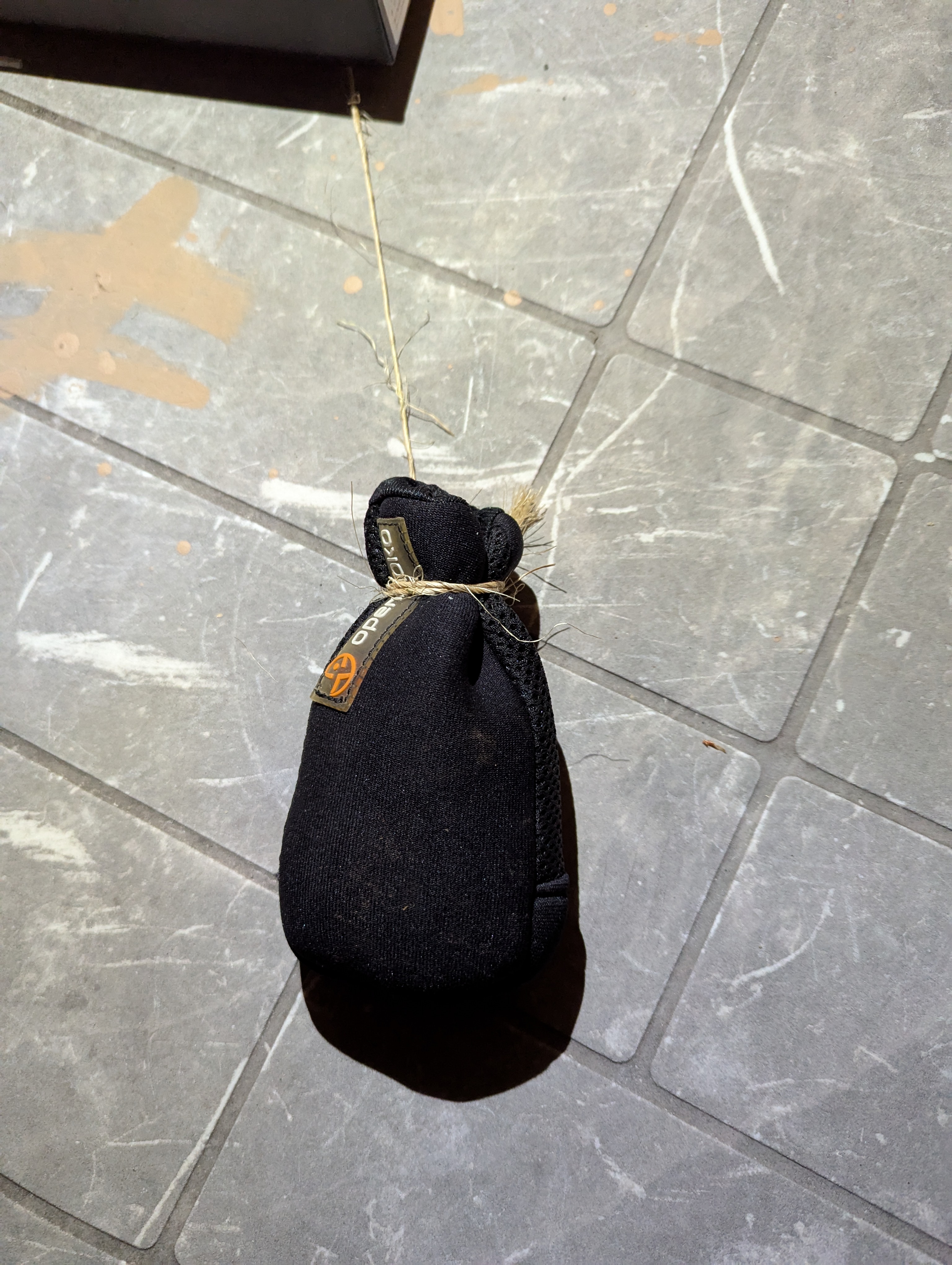 Pouch and gravel tied with twine